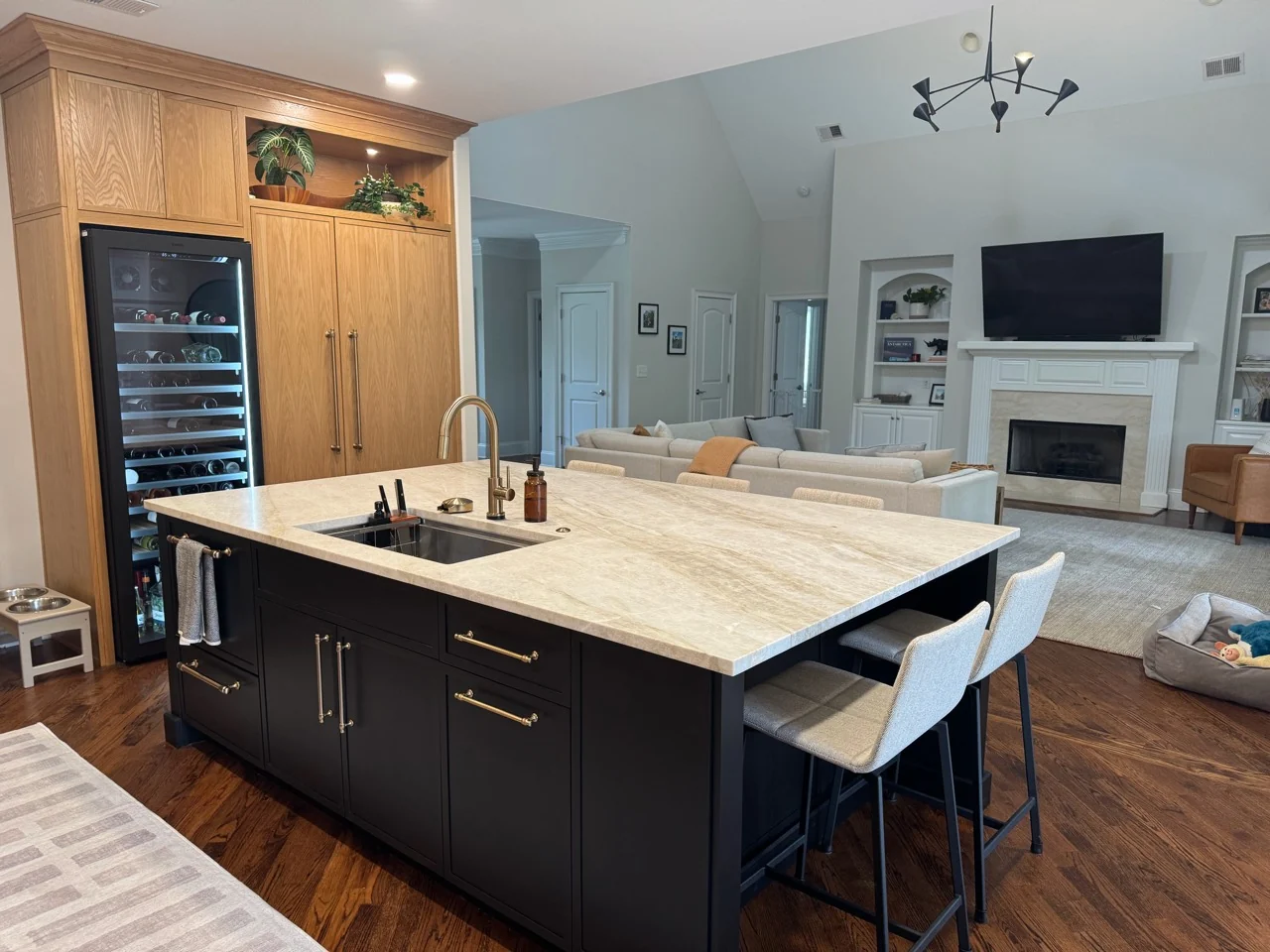Kitchen island opening into the living room with a fireplace