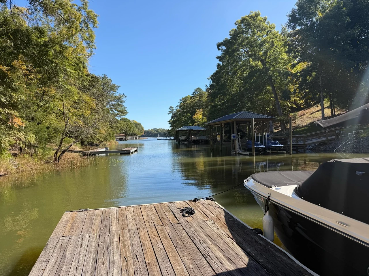 View from the wooden dock along the wooded cove toward the wider lake